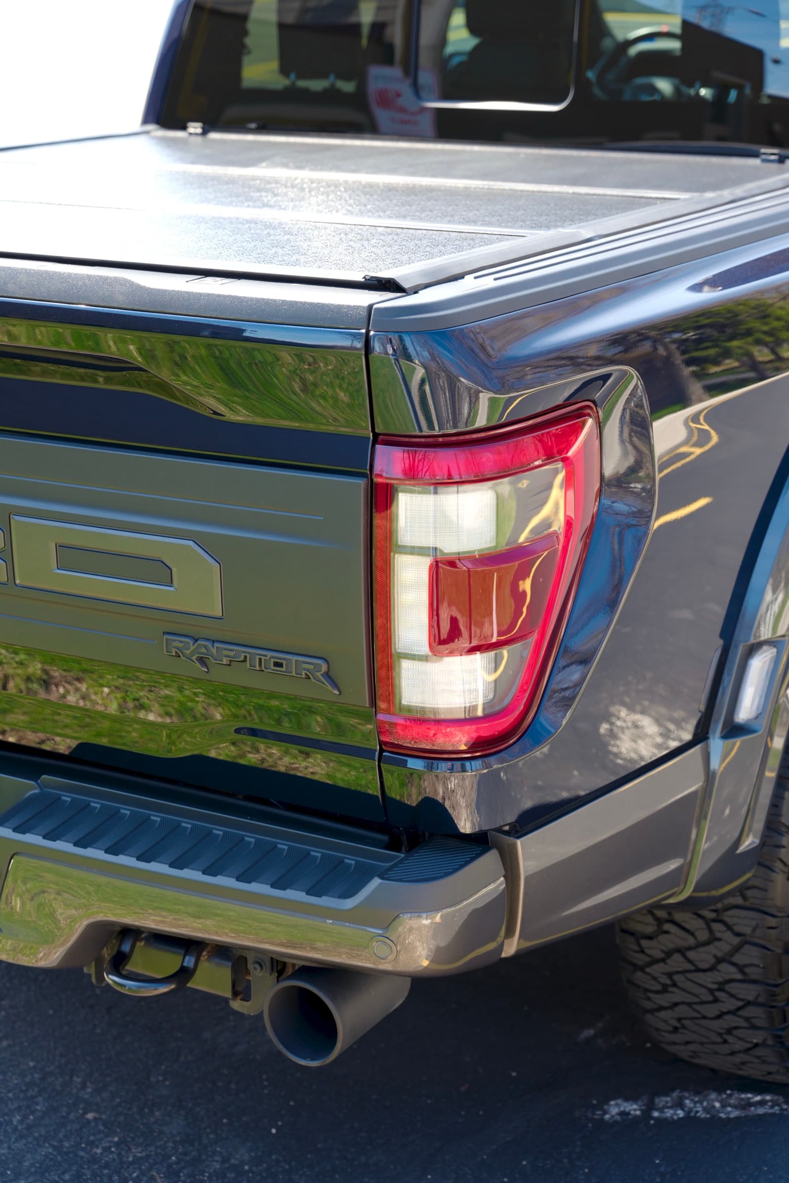 Ford F-150 Raptor — rear tailgate, badge, and tail-light detail