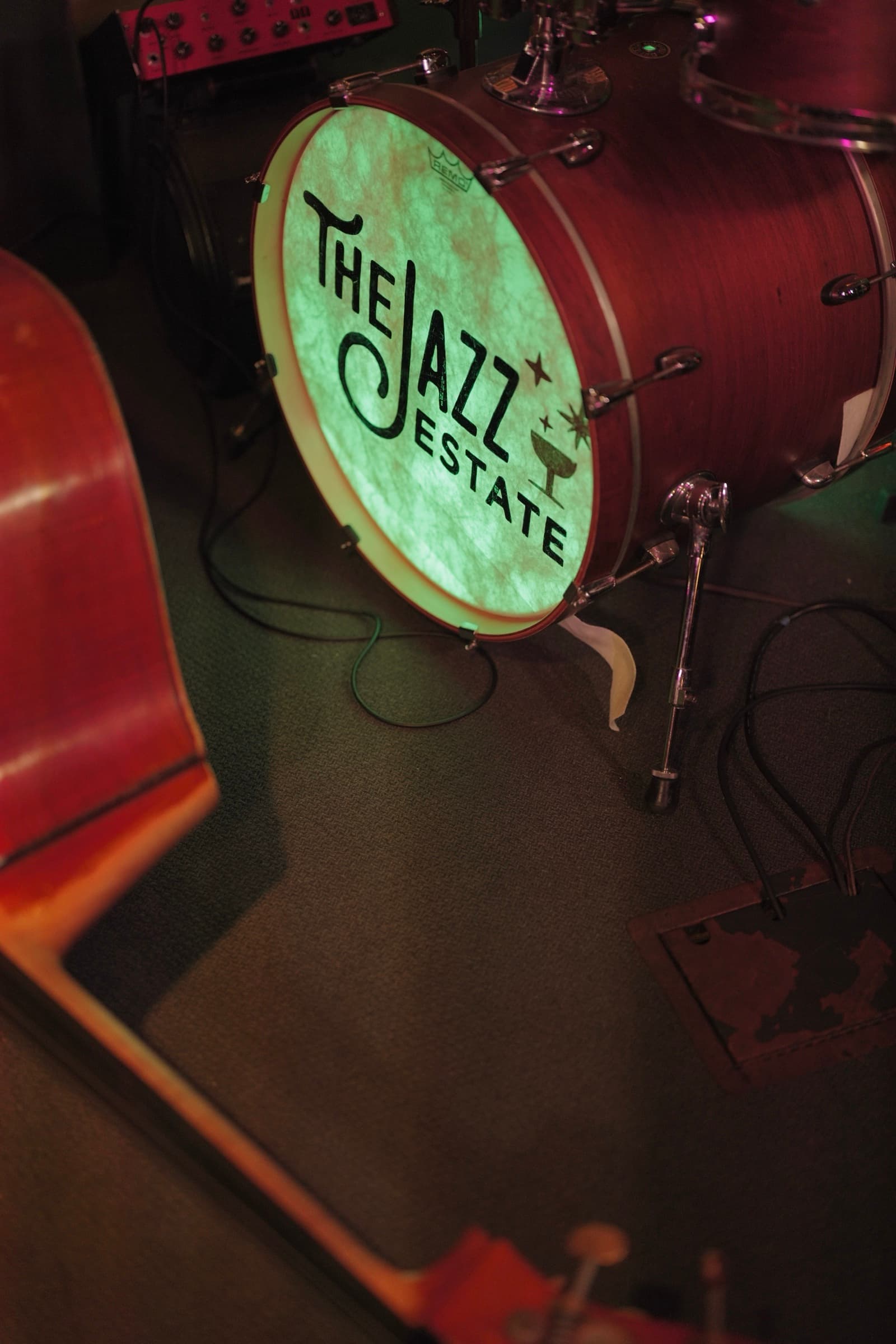 Jazz Estate logo drum kit and upright bass on stage